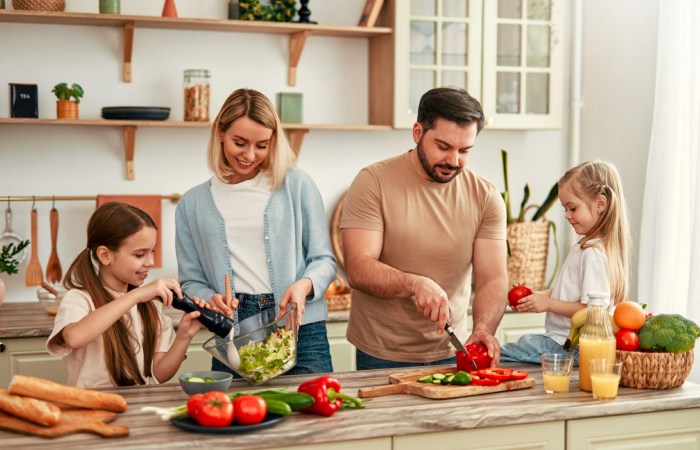 Family preparing whole food meal together in a bright kitchen